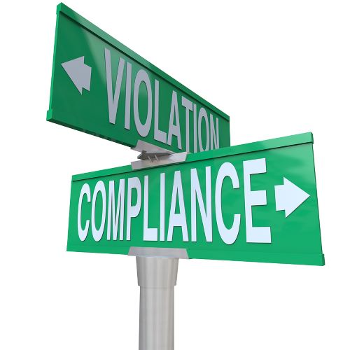 Compliance A green street sign with white letters points "Violation" in one direction and "Compliance" in the other.