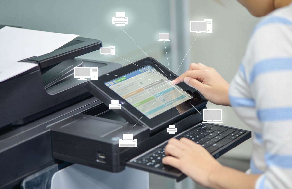 Business woman is using the printer to scan document to network folder with icon of printer and computer