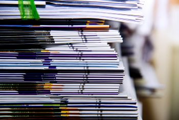 Close-up of a pile of business papers on a desk in an office 