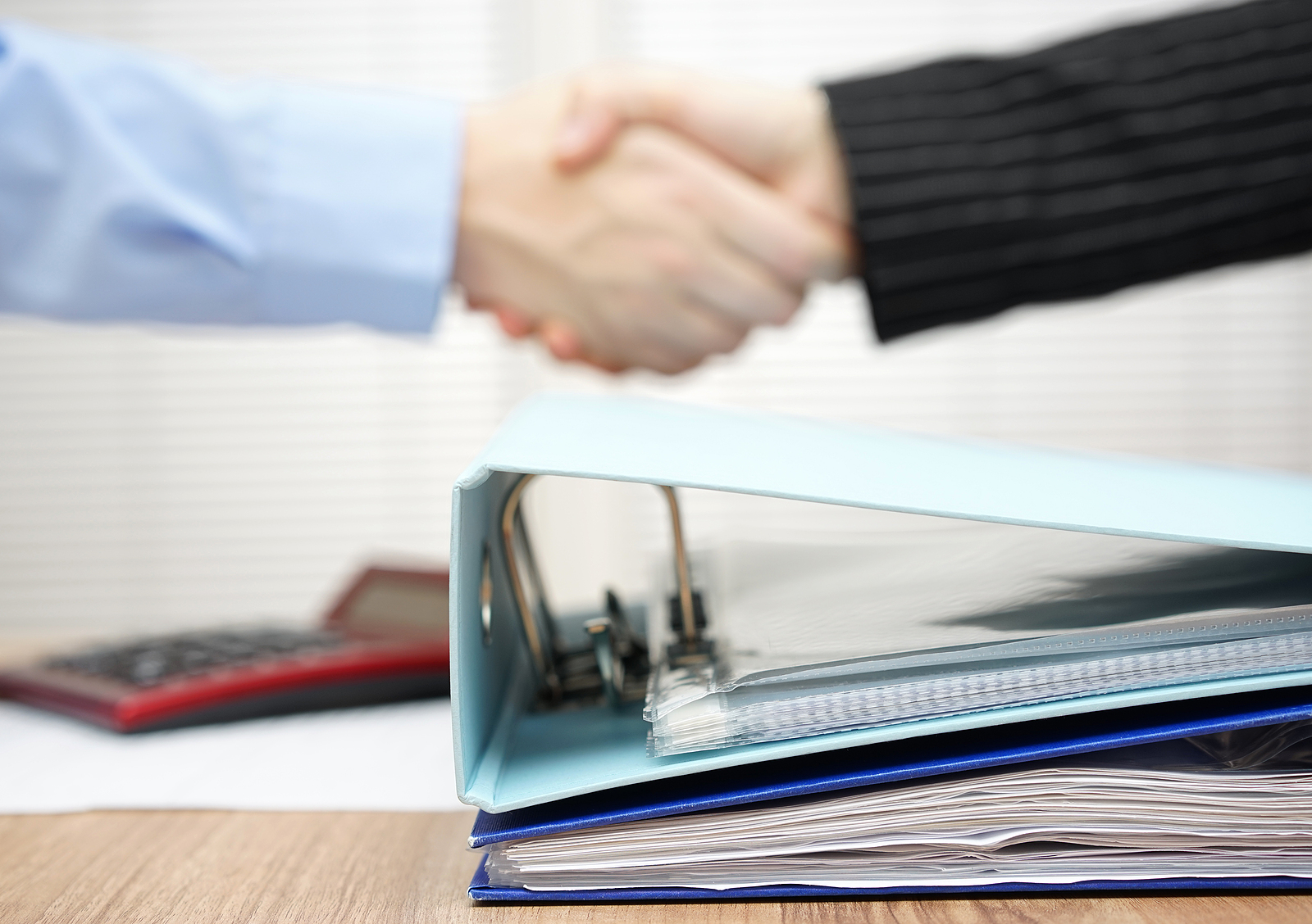 Businesspeople shake hands in a Portland area accounting firm