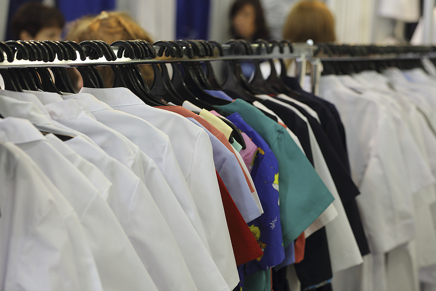uniforms on hangers on a rack awaiting product destruction services