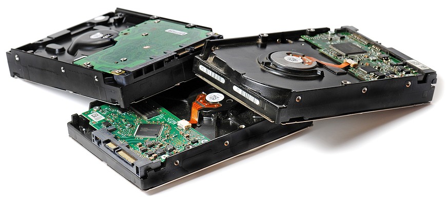 A pile of hard drives on a white background