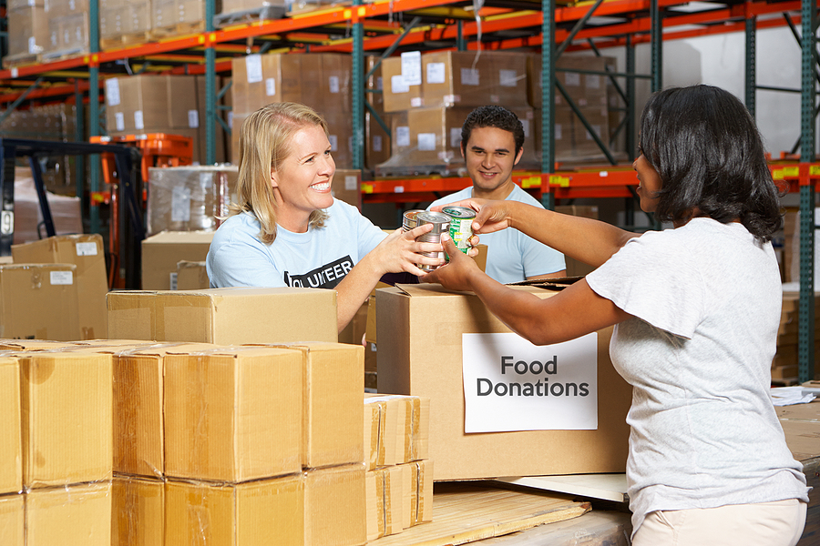 Volunteers Collecting Food Donations In Warehouse